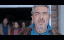 a man with gray hair and a beard is wearing a fur coat