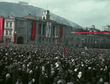 a crowd of people gathered in front of a building