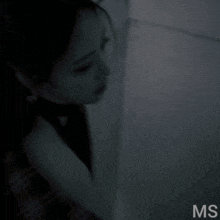 a black and white photo of a woman with the letters ms in the corner