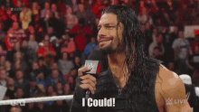 roman reigns is talking into a microphone and saying `` i could '' in front of a crowd .