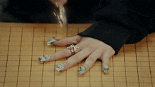 a woman 's hand with a diamond ring on her finger