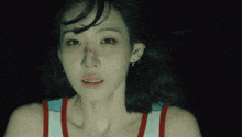 a close up of a woman 's face with a tear running down her cheek