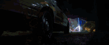 a police car is lit up at night with a blue light on the top