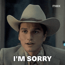 a man wearing a cowboy hat and a suit says i 'm sorry