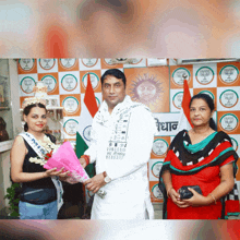 a woman in a miss india crown is being presented with flowers