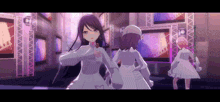 a group of anime girls are standing next to each other on a stage in a video game .