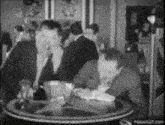 a group of men are sitting at a table in a restaurant .