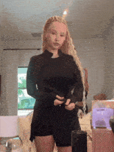 a woman with blonde braids wearing a black jacket