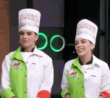 two women wearing chef hats that say " por cada sentadilla " are standing next to each other