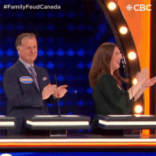 a man and a woman on a family feud canada show