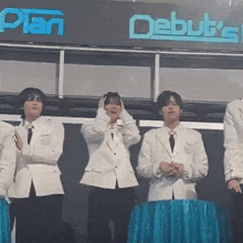 a group of men standing in front of a sign that says debut