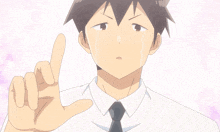 a man in a white shirt and black tie is crying and pointing up