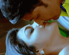 a man and a woman are kissing each other on the lips