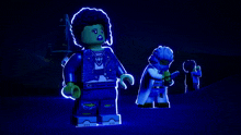 a group of lego figures in a dark room