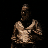 a man with a tattoo on his arm is wearing a brown shirt