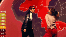 a man and a woman are dancing in front of a map showing mm