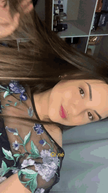 a woman taking a selfie with the words oi ne on the bottom right corner