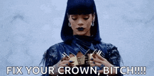 a woman with blue hair is holding a crown in her hands and says `` fix your crown , bitch !! ''