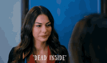 a woman says " dead inside " in front of a blue background