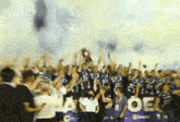 a group of people are standing in front of a banner that says oe on it