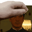 a man wearing a tuxedo and a towel on his head is being touched by a hand .