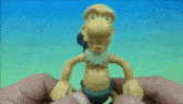 a cartoon character with a big nose is being held by a person
