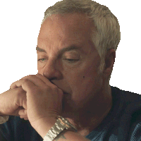 a man wearing a watch is covering his mouth with his hands