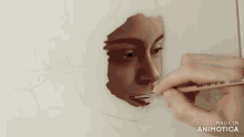 a person is painting a woman 's face with a brush made in animatica
