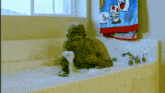 a man is taking a bath in a tub with a toad towel hanging on the wall