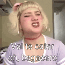 a woman with blonde hair and hoop earrings is making a funny face and saying vai te catar oh bagacero .