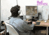 a man wearing headphones is playing a video game on a computer screen that says hi-tech boutique on it