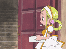 a girl with green hair is standing in front of a door holding a box