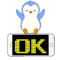 a blue and white penguin is sitting on top of a phone that says ok