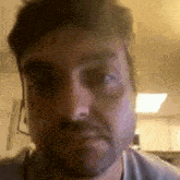 a close up of a man 's face with a beard and a headset on .