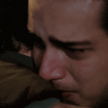 a close up of a man 's face with a watch on it