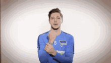 a soccer player wearing a blue shirt with the number 5 on it
