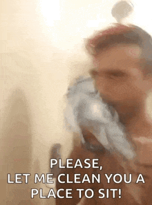 a man is taking a shower and holding a soap dispenser in his mouth .