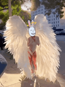 a cartoon angel with wings and a bunny halo