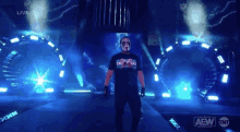 a wrestler is walking down a stage with a tnt logo on the bottom