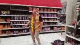 a man in a hot dog costume is standing in a store