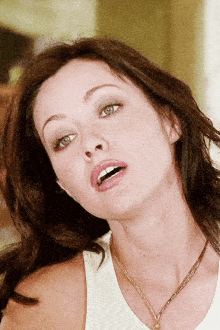 a close up of a woman wearing a necklace