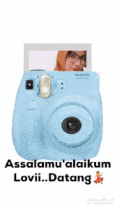 a blue fujifilm camera with a picture of a woman