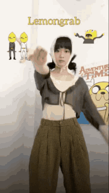 a girl is dancing in front of a sign that says lemongrab