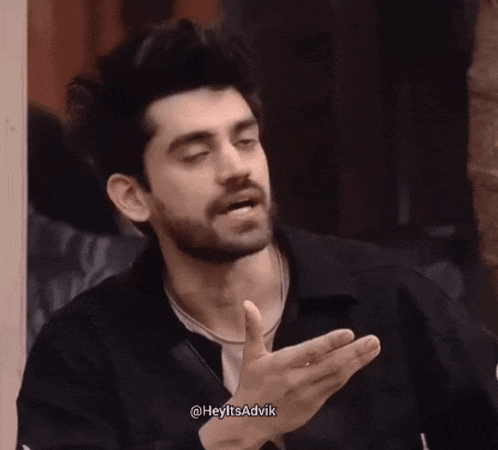 a man with a beard is wearing a black jacket and says heyitsadvik in the corner