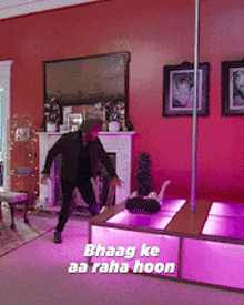 a man is standing next to a pole in a living room with the words bhaag ke aa raha hoon written on the bottom