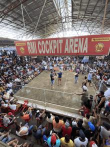 a crowd of people are watching a boxing match at rmi cockpit arena