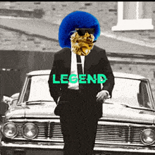 a man in a suit and tie is standing in front of a car with the word legend on it