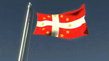 a red white and yellow flag with a cross and stars on it