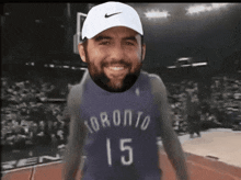 a man wearing a toronto jersey and a white hat