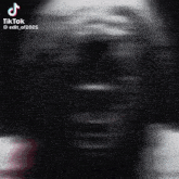 a blurred image of a person 's face with tiktok written on the bottom right